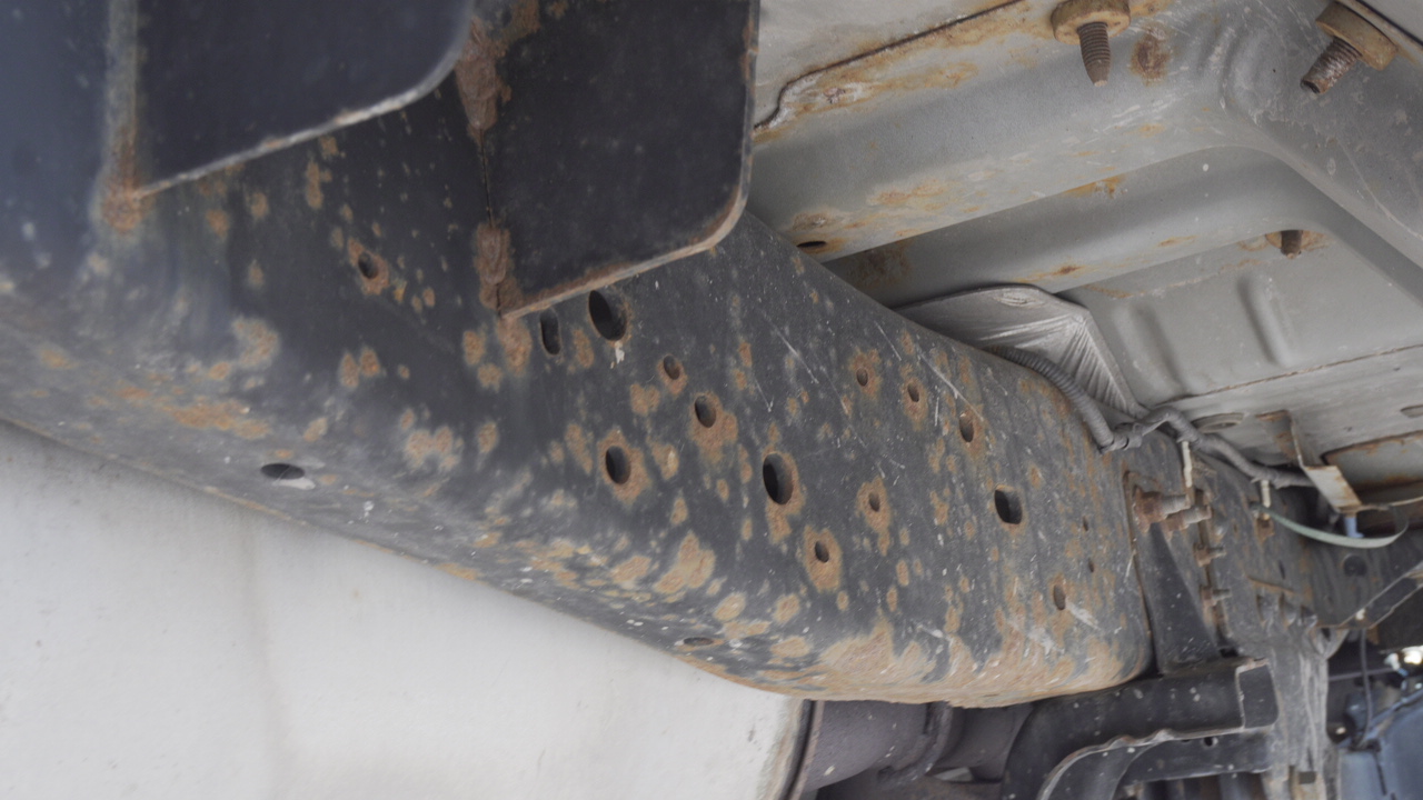 Rust spots on underbody of vehicle.